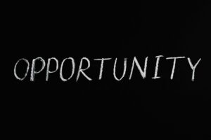 Word 'Opportunity' written in chalk on a black chalkboard, symbolizing new possibilities.