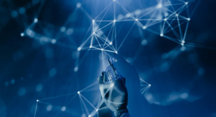 A robotic hand reaching into a digital network on a blue background, symbolizing AI technology.